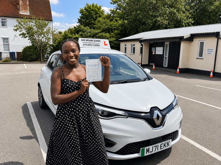 Woman in polka dot dress posing next to a white Renault electric car in a parking lot