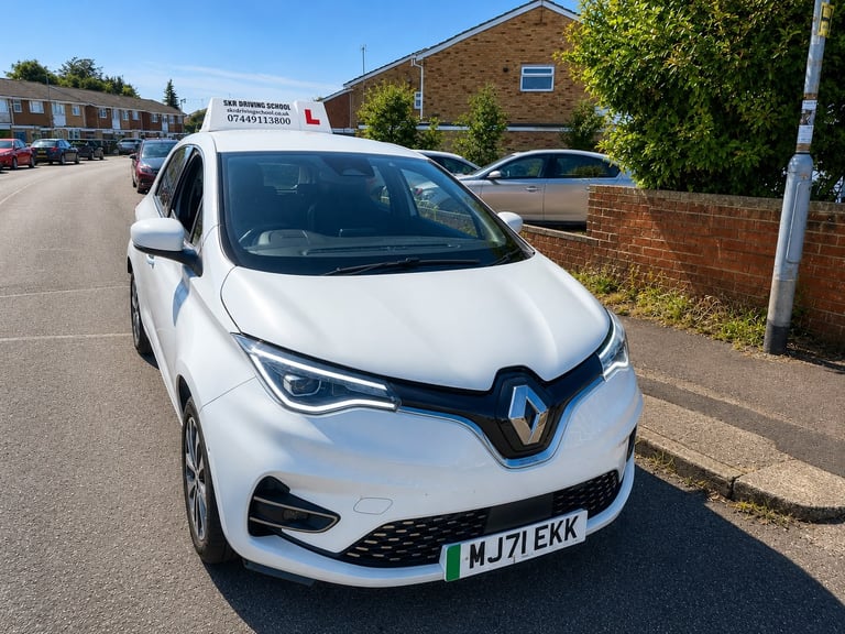 White Renault electric car parked on street